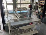 white wrought iron table and chairs in a store