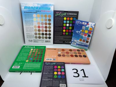 many different colors of eyeshadow on the table