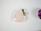 a pink heart and a purple heart on a white table