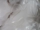 a close up of a glass vase with a bird on it