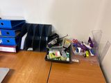 a desk with a laptop and a bunch of office supplies on it
