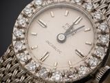an image of a close up of a wrist watch with diamonds on it