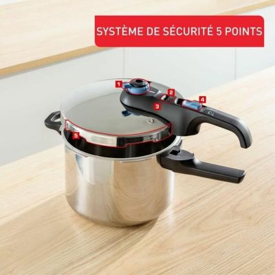 an image of a pressure cooker sitting on top of a wooden table