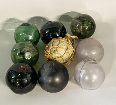 a lot of different colored glass balls on a white surface