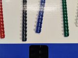four different colored pens sitting on top of a white box