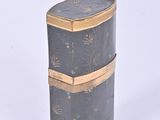 a black and gold box on a white surface