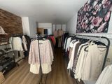 a room with clothes on racks and clothes on hangers