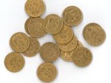 a lot of coins that are on a white surface