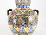 a vase with a colorful design on it on a white background