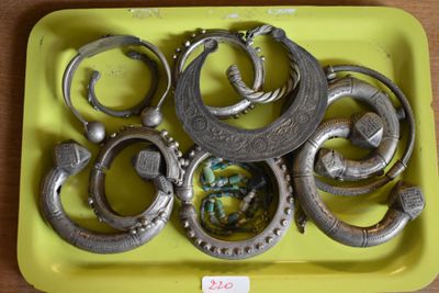 a yellow tray with a bunch of silver rings on it