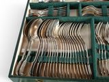 a green case with silverware in it on a table