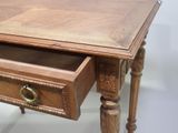 a small wooden table with a drawer on it