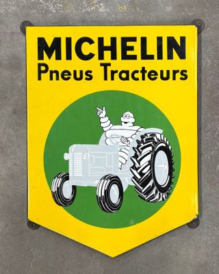 yellow and green sign of a tractor with a man on it