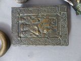 a metal plaque with a picture on it next to other items