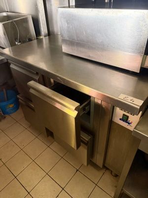 a large stainless steel counter with a microwave in it