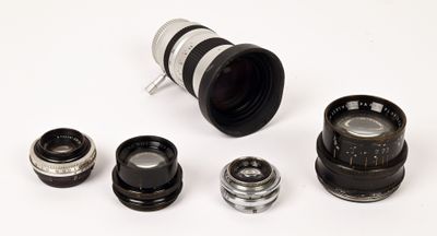 a lot of different types of camera lenses on the table