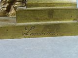a bronze statue of a woman sitting on a step