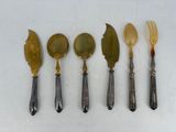 five different types of silverware on a white surface