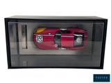 a red toy car in a glass case