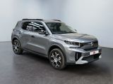 a silver suv parked in a room with a black floor
