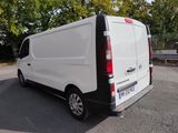 a white van parked in a parking lot with trees in the background