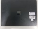 the back of a black laptop with a sticker on it