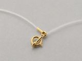 a close up of a gold plated charm on a white string