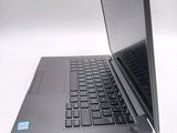 a laptop computer sitting open on a white surface