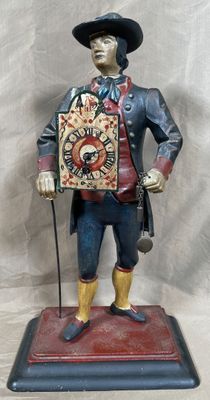 Pendule en fonte laquée polychrome représentant un colporteu…