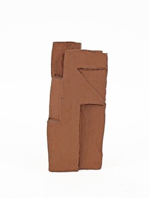 a clay sculpture of a letter f on a white surface