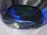a close up of a glass vase with a blue and green design on it