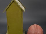 a small wooden house and a hard hat next to each other