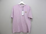 a pink t - shirt hanging on a hanger on a wall