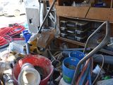 a pile of junk in a garage with a lot of tools