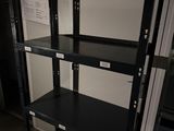a black shelf that has a bunch of shelves on it