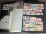 an open book with stamps on it on a table