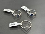 three rings with tags on them sitting on a table