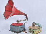 a red and blue gramphone next to a blue and green box