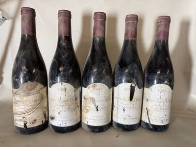 six bottles of wine are lined up on a shelf