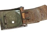 an old belt with a metal buckle on a white background