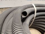 a black hose that is laying on the ground