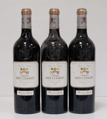 three bottles of wine sitting on top of a white table