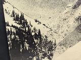 a black and white photo of a person on a snowboard