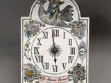 a clock with a bird on it on a stand