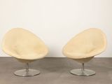 pair of lounge chairs in the style of the egg chair