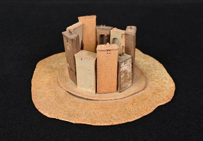 a small model of a castle on a black surface