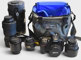 many cameras and a camera bag on the table