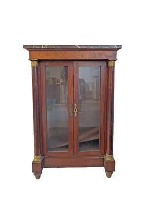 a wooden cabinet with glass doors and a marble top