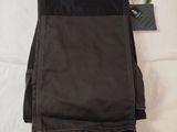 a pair of black pants laying on a bed