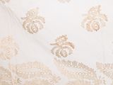 an image of a close up of a white dress with gold embroidery